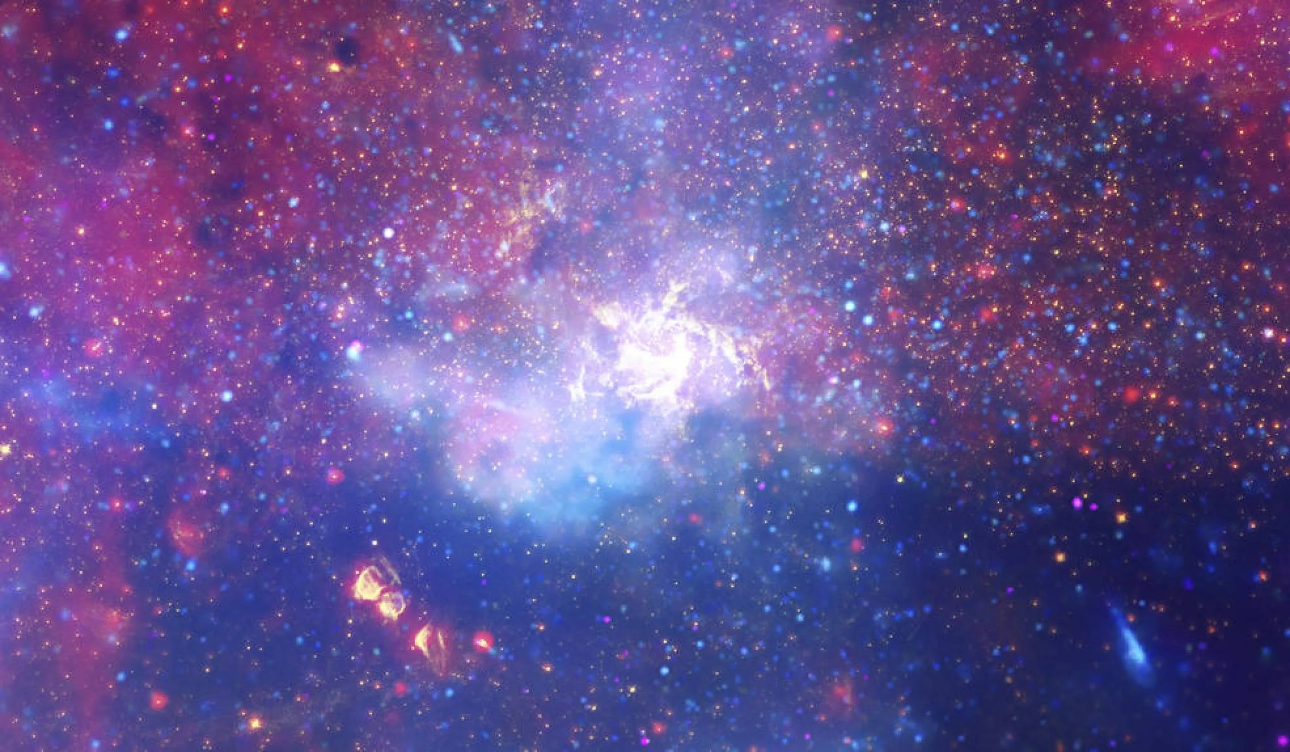 Un enorme remolino de gas caliente brilla con luz infrarroja, marcando la ubicación aproximada del agujero negro supermasivo en el corazón de nuestra galaxia, la Vía Láctea.