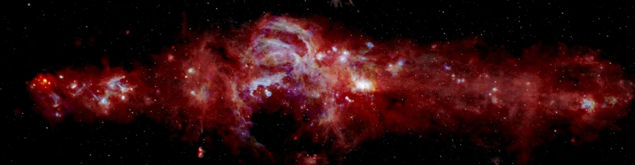 Imagen infrarroja compuesta del centro de nuestra Vía Láctea. Abarca más de 600 años luz y está ayudando a los científicos a saber cuántas estrellas masivas se están formando en el centro de la galaxia. Los datos de SOFIA (azul y verde) se combinan con los del Observatorio Espacial Herschel (rojo) y el telescopio espacial Spitzer (blanco). La vista de SOFIA reveló características que nunca se habían visto antes. Créditos: NASA/SOFIA/JPL-Caltech/ESA/Herschel