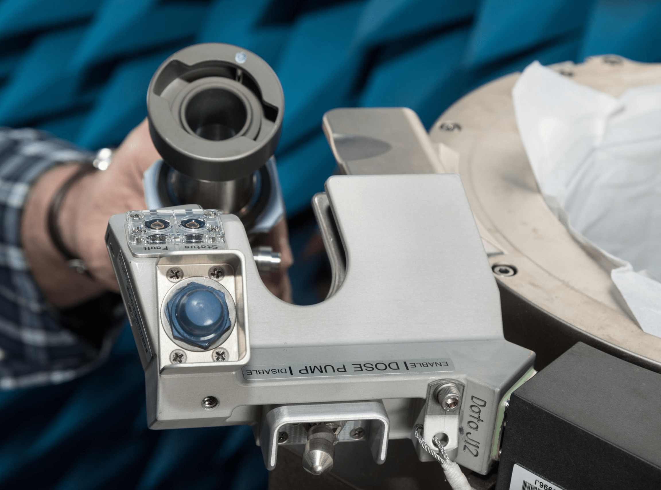 La imagen muestra una mano borrosa en el fondo que sostiene el Sistema Universal de Gestión de Residuos que utilizarán los integrantes de la tripulación de Artemis II.