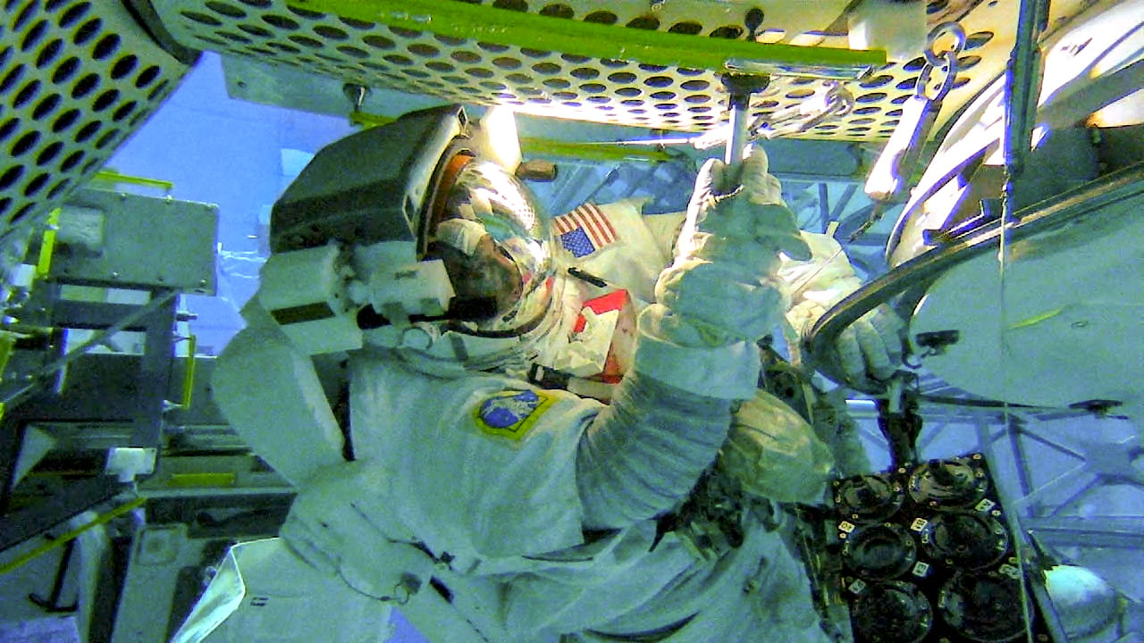 El astronauta de la NASA Victor Glover se entrena para la caminata espacial de la investigación Microorganismos Externos de la EEI en la piscina del Laboratorio de Flotabilidad Neutral en el Centro Espacial Johnson de la NASA en Houston.