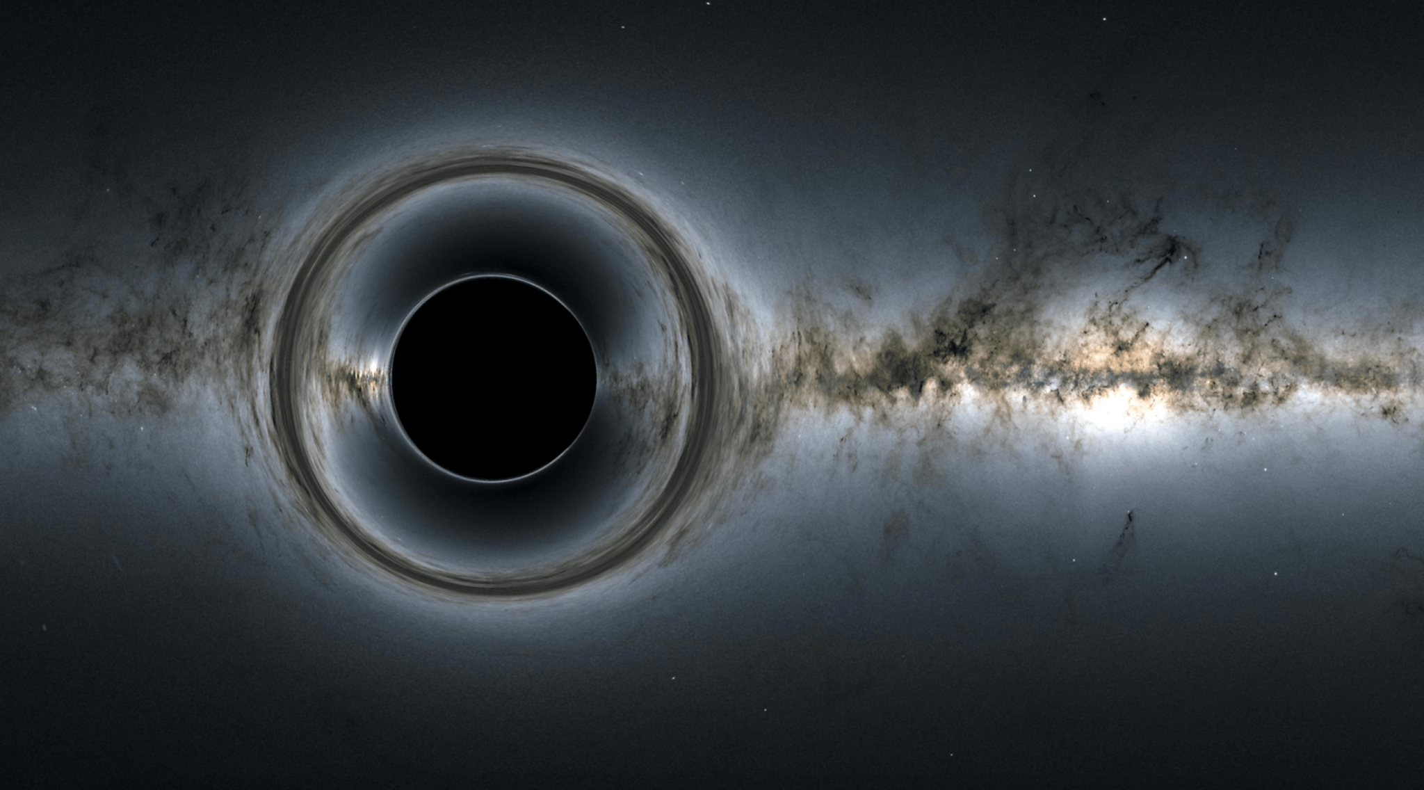 Esta simulación de un agujero negro supermasivo muestra cómo distorsiona la región estrellada y captura la luz, creando la silueta de agujero negro.